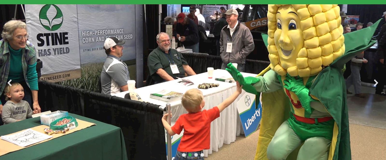 child next to corn