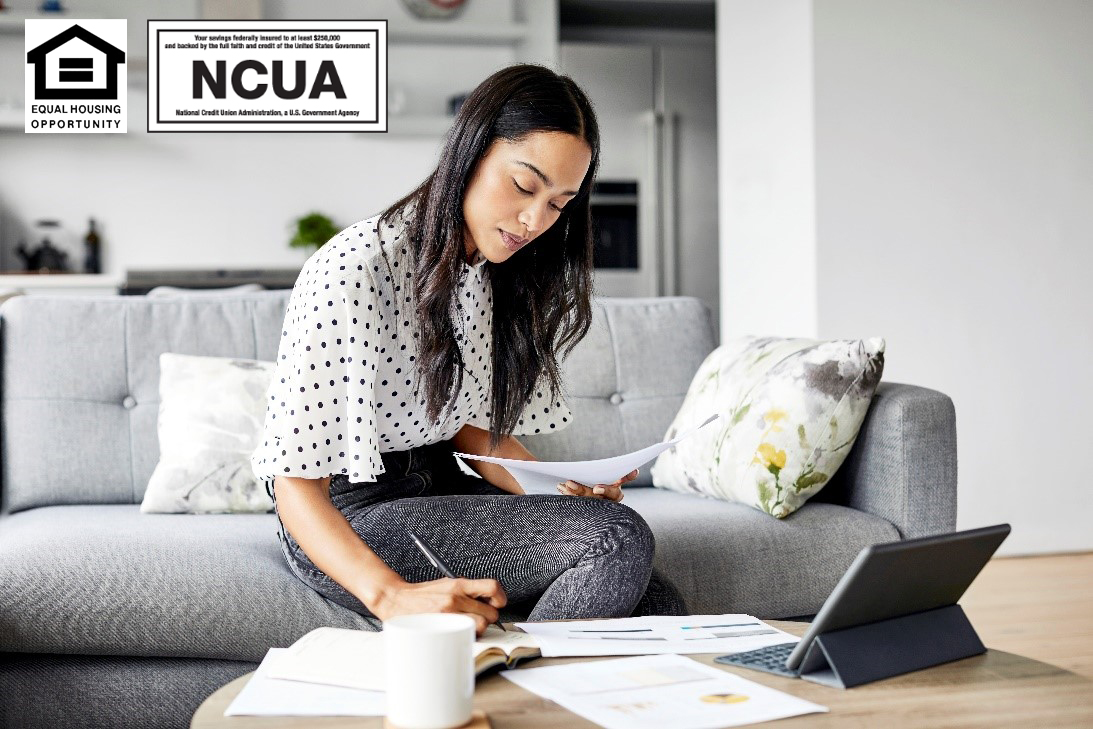 Financial Blog | Woman looking at papers on a table